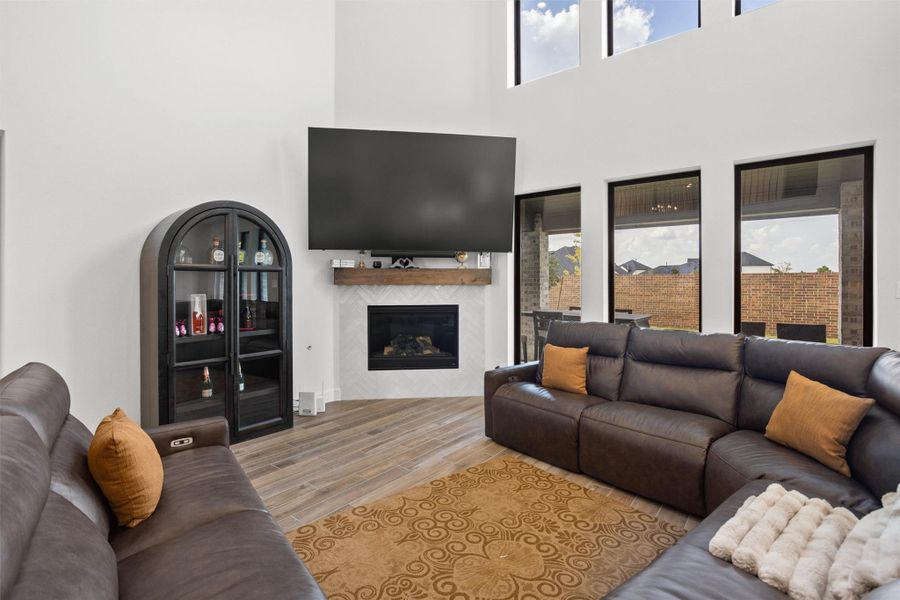 Soaring family room with fireplace and wall of windows