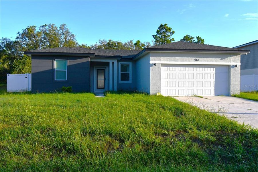 Front exterior of a new home in , Poinciana, FL, highlighting curb appeal (Image 24). Front exterior of a new home in , Poinciana, FL, highlighting curb appeal (Image 24).