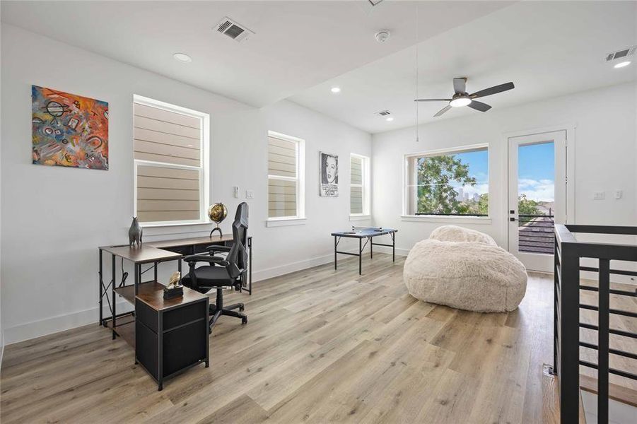 Here is another view of this amazing and bright flex space! Low-e insulated windows keep the home cool in the summer months yet allow you to enjoy gorgeous views of downtown Houston and the outdoors.-