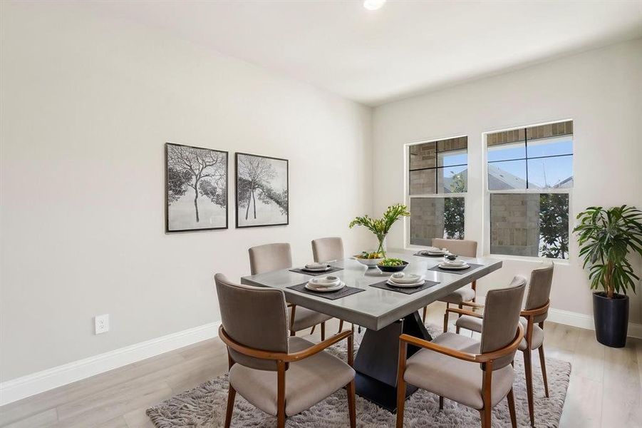 Dining room with light wood-type flooring and recessed lighting Dining room with light wood-type flooring and recessed lighting