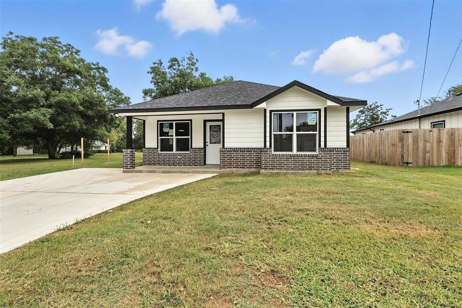View of front of home featuring brick siding, roof with shingles, and concrete driveway View of front of home featuring brick siding, roof with shingles, and concrete driveway