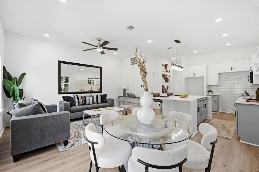 Open concept kitchen, dining and living room, with lots of natural light.
