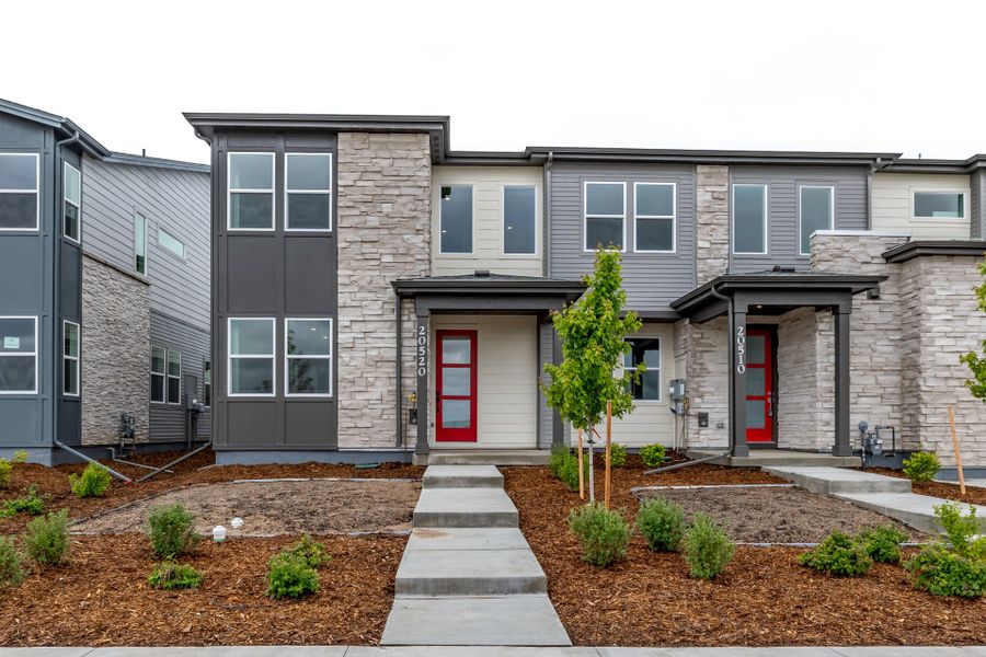 Front exterior of a new home in Painted Prairie, Aurora, CO, highlighting curb appeal (Image 1).