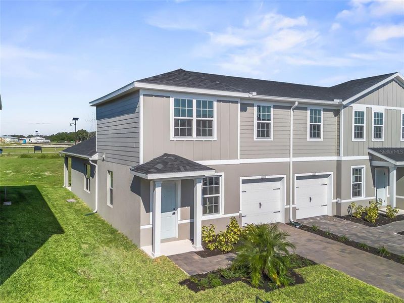 Front exterior of a new home in , Lady Lake, FL, highlighting curb appeal (Image 2).