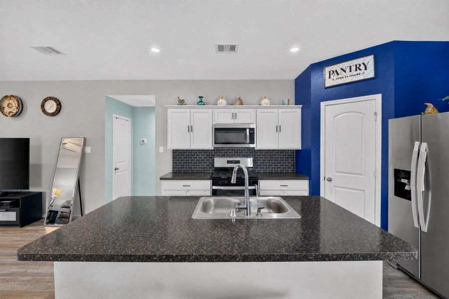 The open layout keeps the kitchen connected to the dining and living areas, creating a functional space for everyday living and entertaining. The open layout keeps the kitchen connected to the dining and living areas, creating a functional space for everyday living and entertaining.