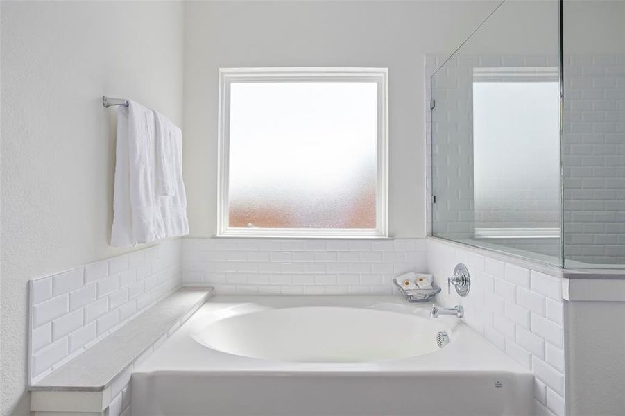 Bathroom featuring a bath to relax in