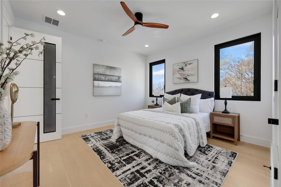 Bedroom featuring a ceiling fan, light wood-style flooring, and recessed lighting