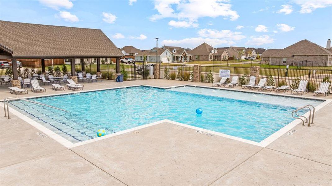 Community pool featuring a patio area and a residential view