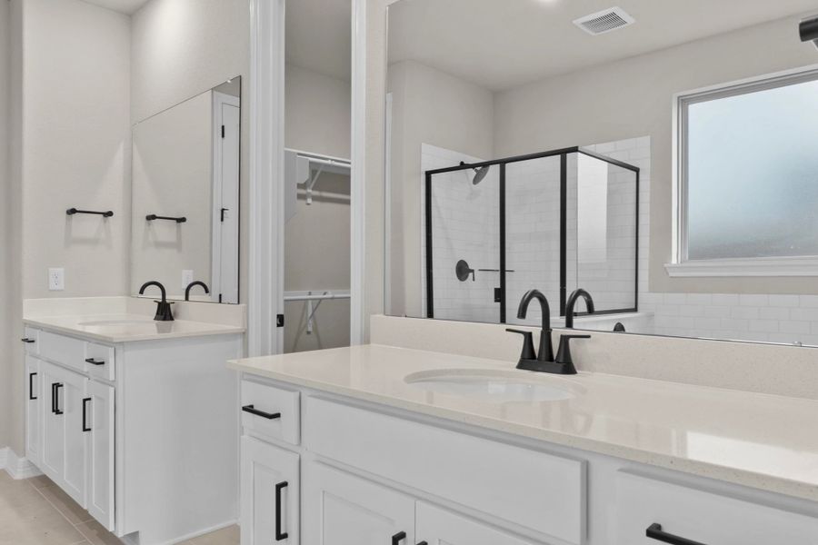 Primary bathroom.  Sample product photo. Actual exterior and interior selections may vary by homesite. Photo may be virtually staged.