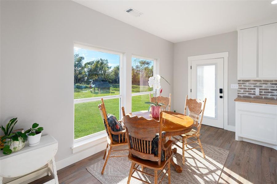 Dining space featuring a healthy amount of sunlight and light hardwood / wood-style flooring