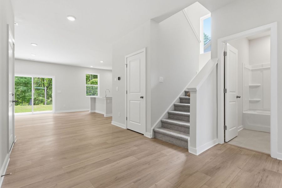A room with white doors and wood floors.