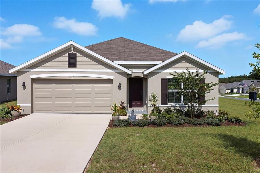 Front exterior of a new home in Fairways at Twisted Oaks, Beverly Hills, FL, highlighting curb appeal (Image 1).