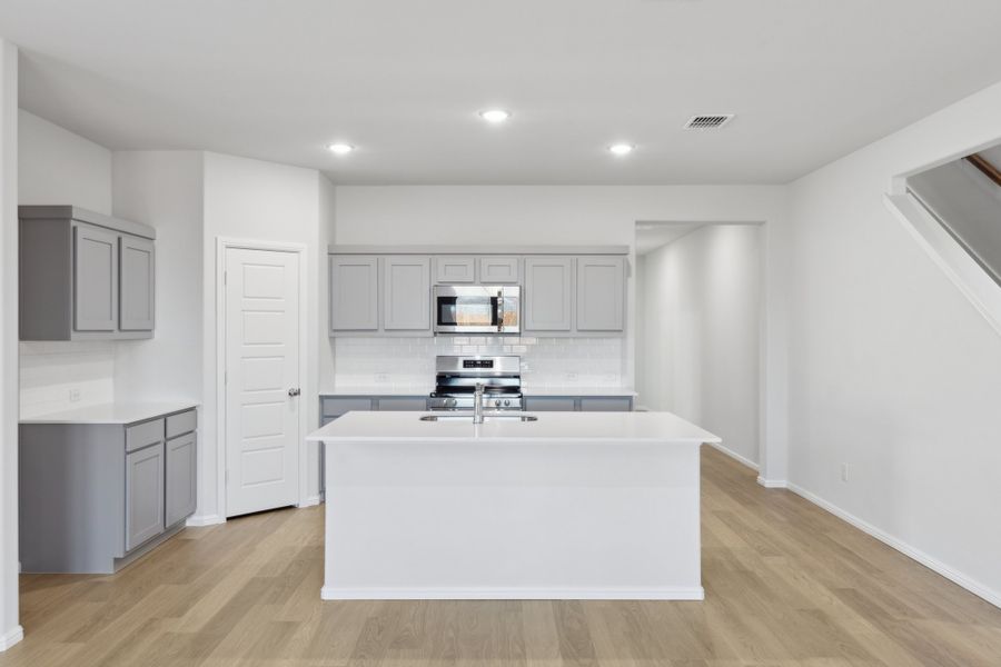 Kitchen in the Holden home plan by Trophy Signature Homes – REPRESENTATIVE PHOTO