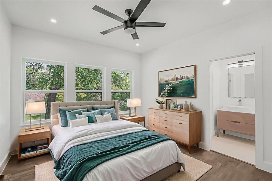 Bedroom with multiple windows, wood finished floors, recessed lighting, and ceiling fan