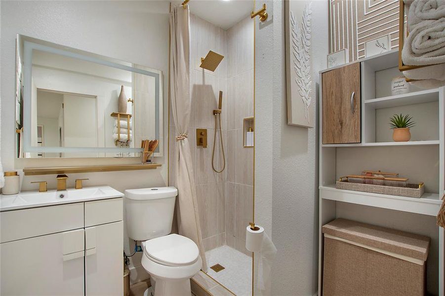 Bathroom featuring a shower stall and vanity Bathroom featuring a shower stall and vanity