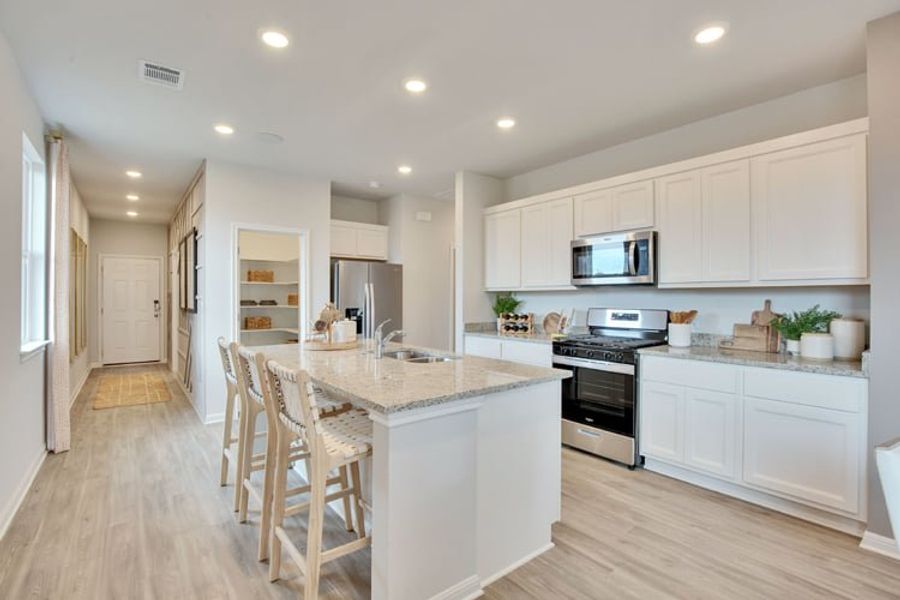 A kitchen with white cabinets. A kitchen with white cabinets.