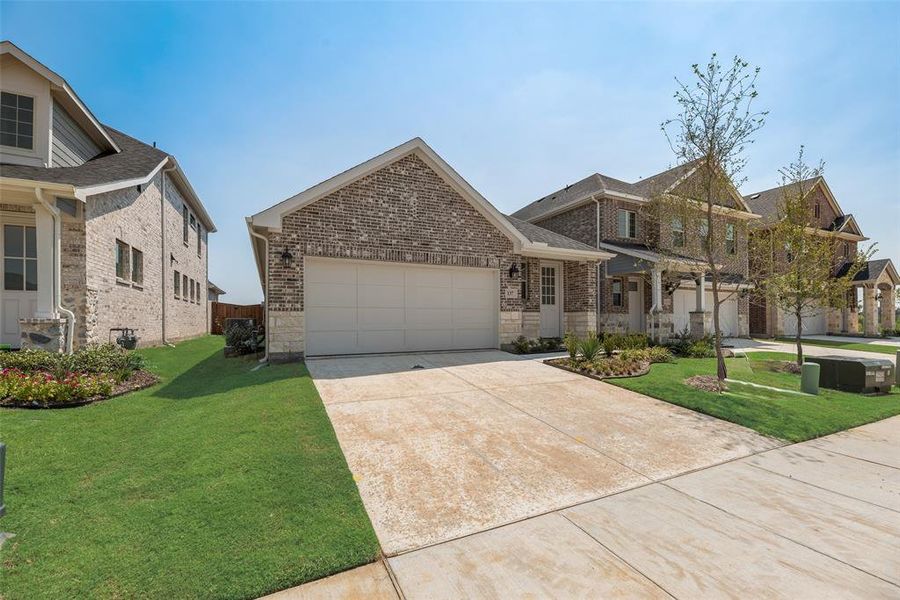 Front exterior of a new home in Spiritas Ranch, Little Elm, TX, highlighting curb appeal (Image 18). Front exterior of a new home in Spiritas Ranch, Little Elm, TX, highlighting curb appeal (Image 18).