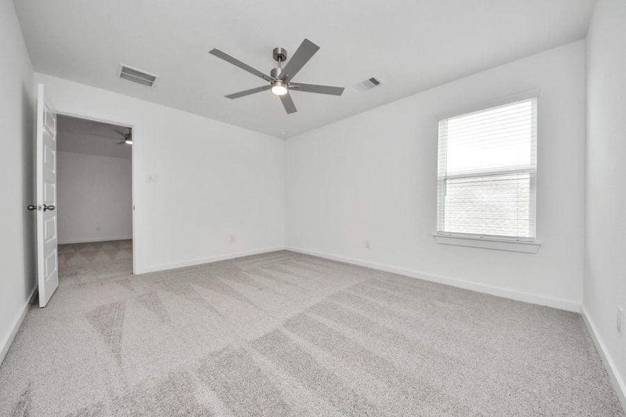 Generously sized secondary bedrooms featuring spacious closets, soft and inviting carpeting underfoot, large windows allowing plenty of natural light, and the added touch of privacy blinds for your personal retreat. Sample photo of completed home with similar floor plan. Actual colors and selections may vary.