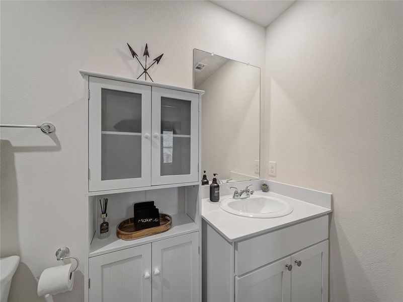 Primary Ensuite Bathroom with vanity and a textured wall