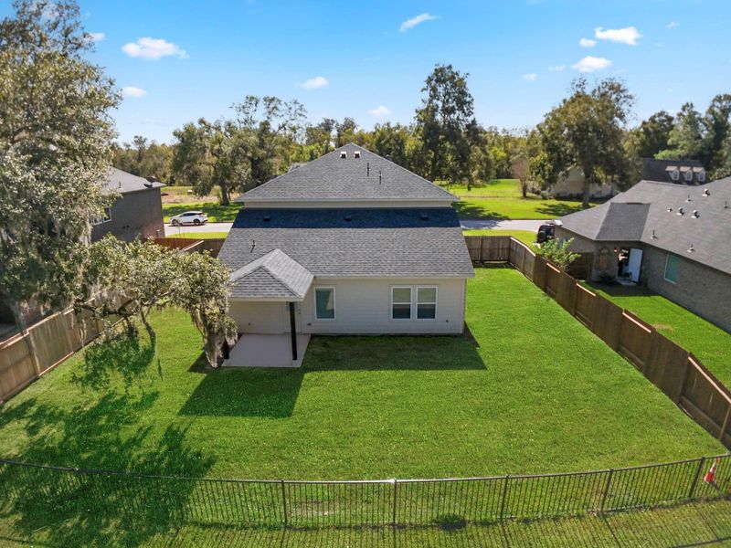Spectacular aerial view showcasing the home’s prime location on the Columbia Lakes Golf Course! This expansive backyard offers unobstructed views of the lush fairways and natural surroundings, creating a serene backdrop for everyday living. The covered patio extends your living space outdoors, while the fully fenced yard provides both privacy and safety—ideal for family gatherings, pets, and entertaining. Experience resort-style tranquility right from your own backyard!
