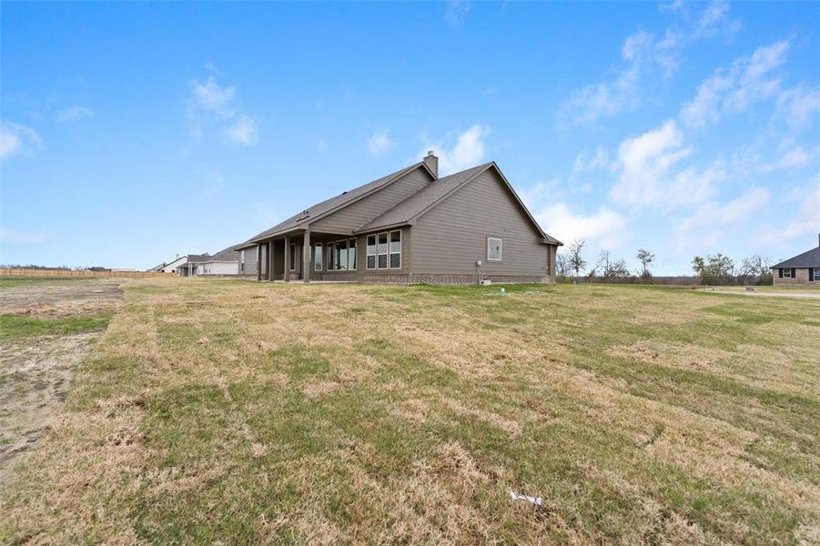 Back of house with a yard, a patio area, and a chimney Back of house with a yard, a patio area, and a chimney