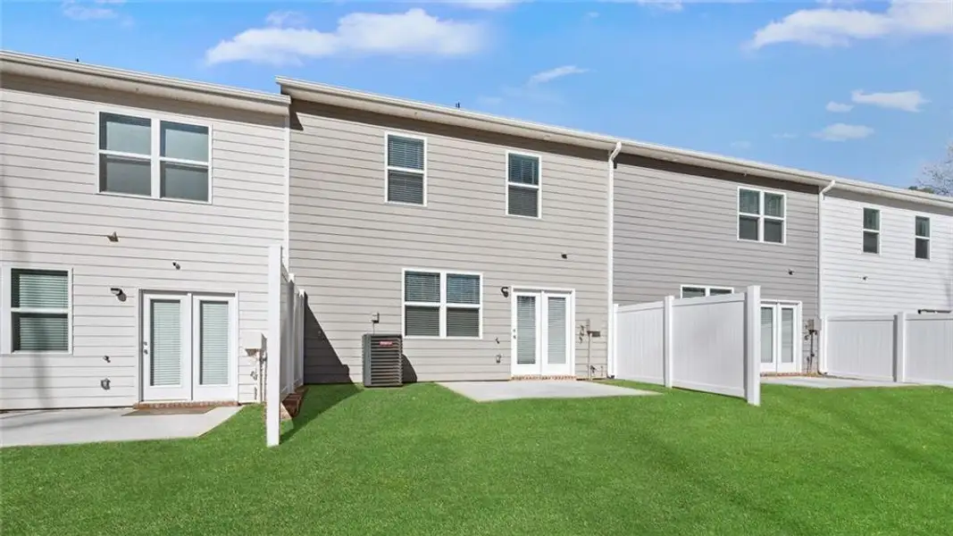 Exterior details and patio area of a home in Inverness at Sugarloaf, Lawrenceville (Image 4).