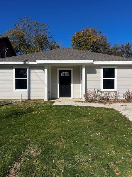 Entrance to property featuring a lawn