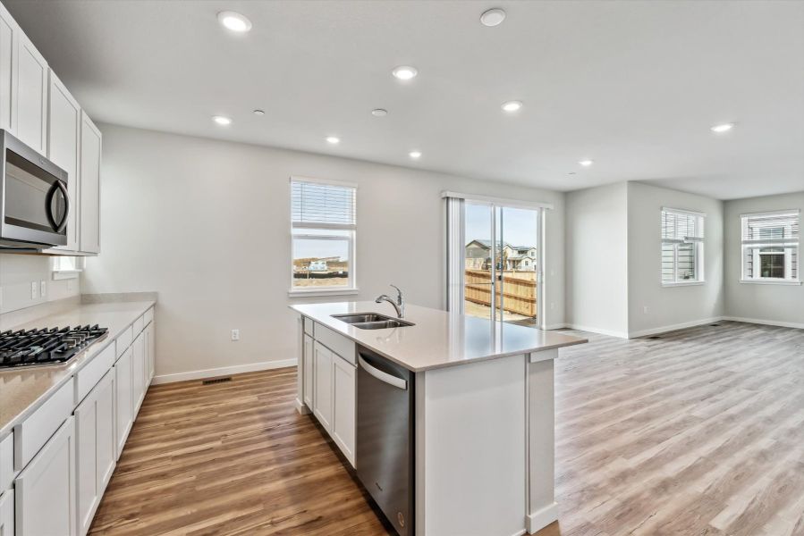 A kitchen with white cabinets.