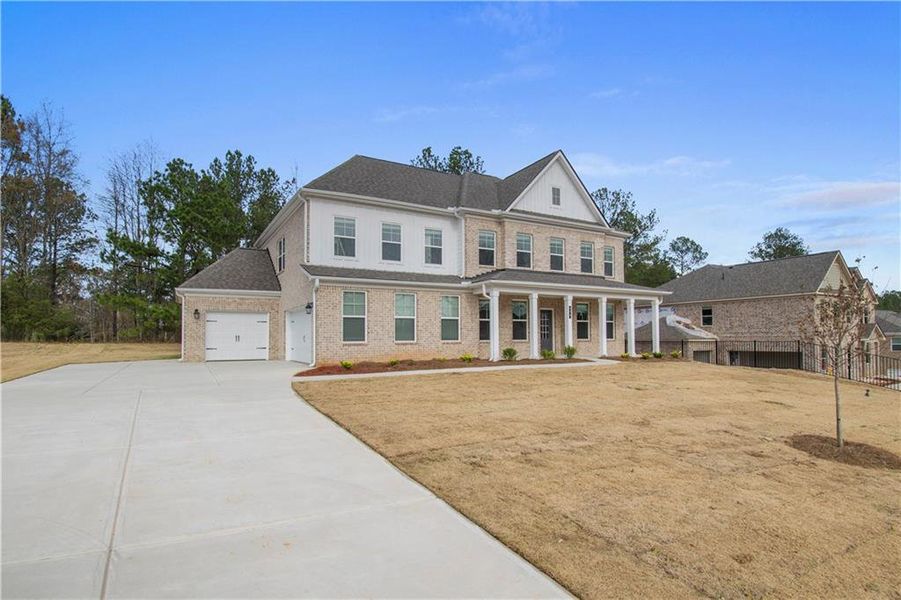 Front exterior of a new home in Cambria at Traditions, Hampton, GA, highlighting curb appeal (Image 17). Front exterior of a new home in Cambria at Traditions, Hampton, GA, highlighting curb appeal (Image 17).