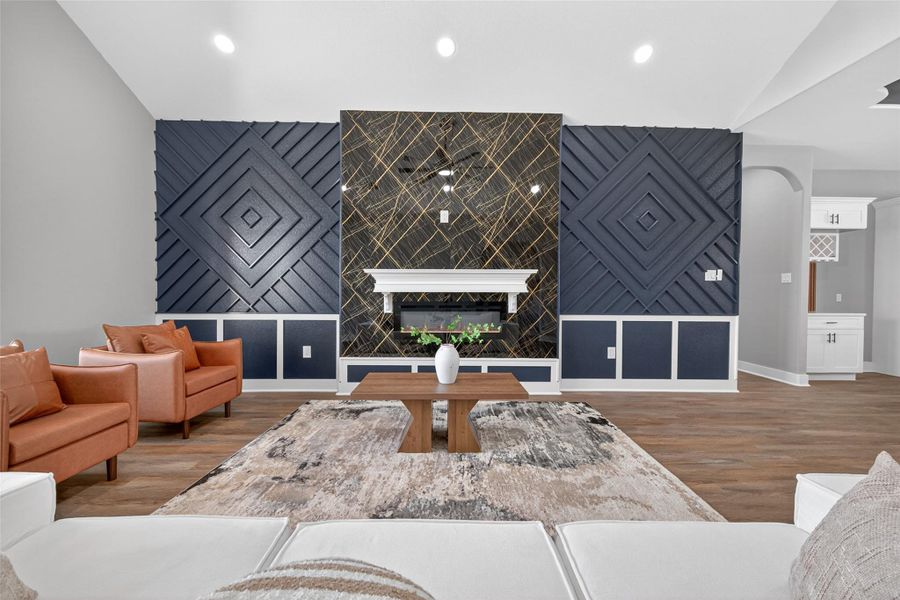 Spacious living room featuring high ceilings, abundant natural light, and a fireplace. Spacious living room featuring high ceilings, abundant natural light, and a fireplace.