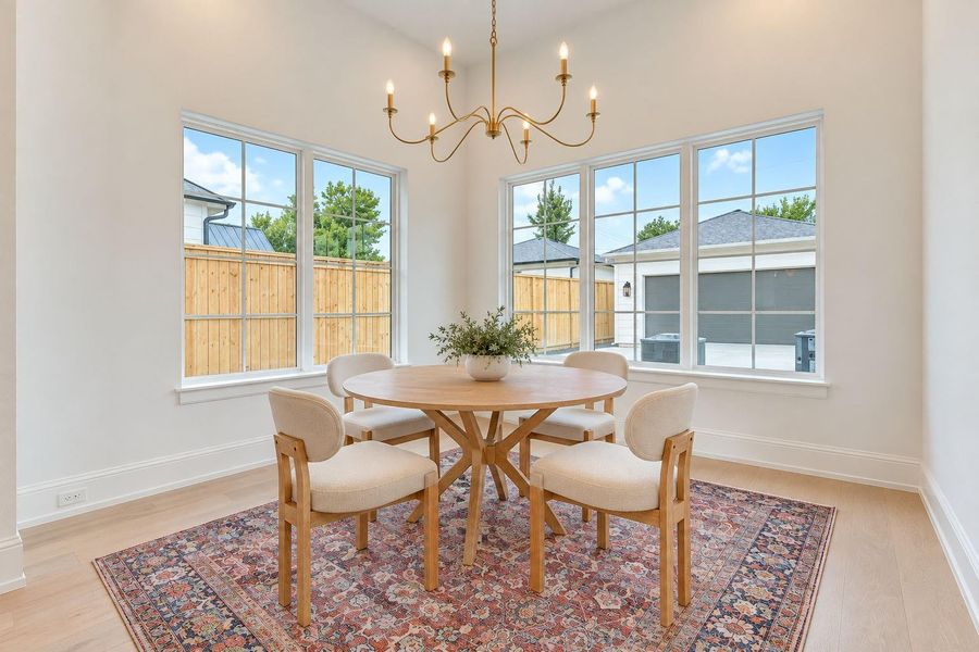 Sun-filled breakfast room surrounded by windows, creating a bright and inviting setting for morning coffee, casual dining, or weekend brunch. French Oak floors and designer lighting add a refined touch, while the intimate layout delivers the perfect blend of everyday comfort and sophisticated luxury living. Sun-filled breakfast room surrounded by windows, creating a bright and inviting setting for morning coffee, casual dining, or weekend brunch. French Oak floors and designer lighting add a refined touch, while the intimate layout delivers the perfect blend of everyday comfort and sophisticated luxury living.