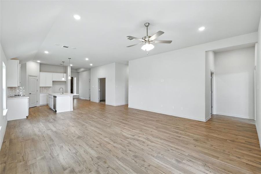 Unfurnished living room with light wood-type flooring, recessed lighting, and ceiling fan Unfurnished living room with light wood-type flooring, recessed lighting, and ceiling fan