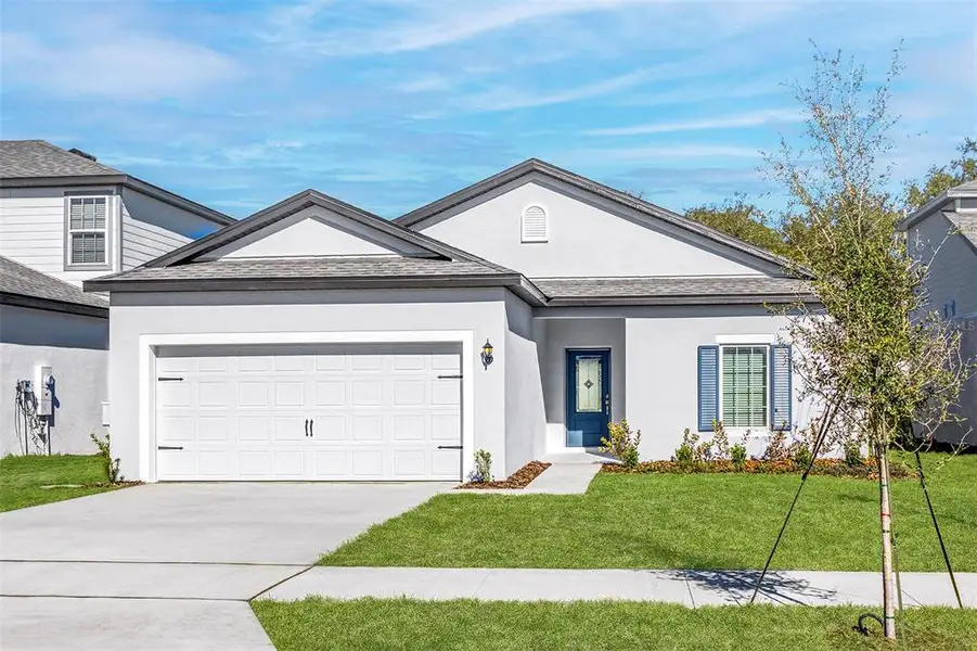 Front exterior of a new home in Tula Parc, Astatula, FL, highlighting curb appeal (Image 1). Front exterior of a new home in Tula Parc, Astatula, FL, highlighting curb appeal (Image 1).