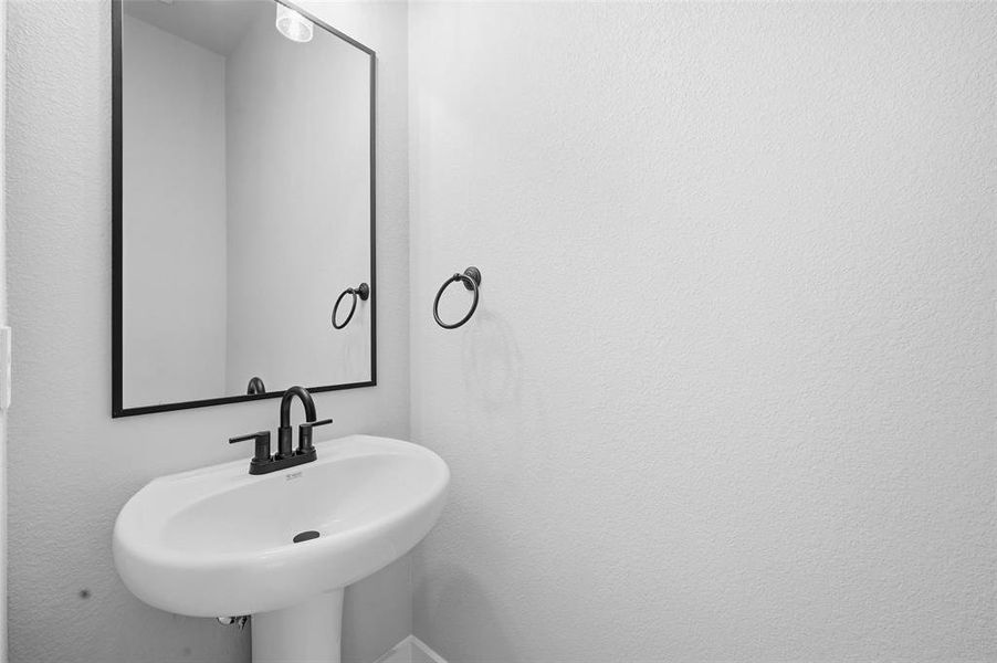 Bathroom with a textured wall and a sink