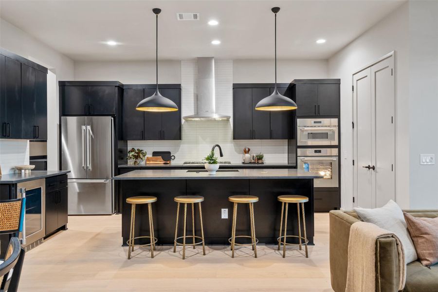 Culinary excellence awaits in this modern kitchen, boasting high-end appliances and a spacious island for gathering. Culinary excellence awaits in this modern kitchen, boasting high-end appliances and a spacious island for gathering.