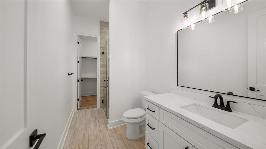 This bathroom features granite countertops, soft closing drawers, and tile floors.