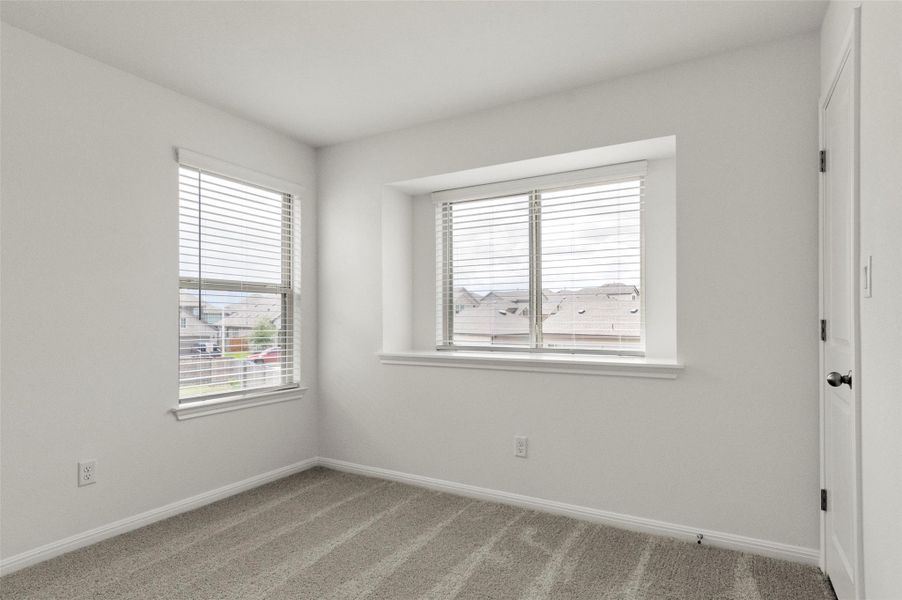 Unfurnished room featuring light colored carpet and baseboards