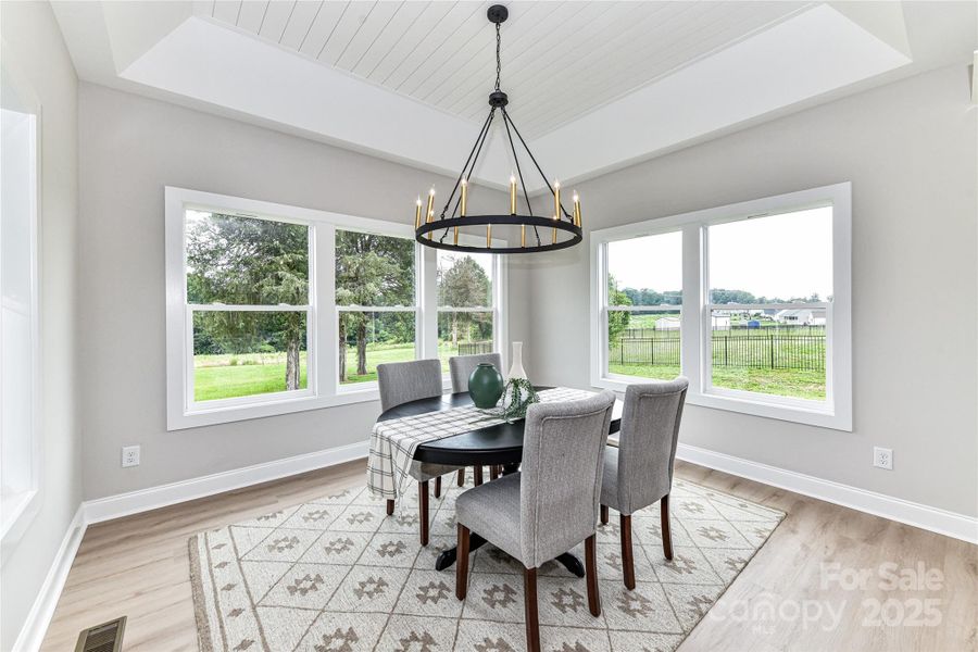 Dining Area with tray, ship lap ceiling, custom light fixture & large windows for great natural light! Dining Area with tray, ship lap ceiling, custom light fixture & large windows for great natural light!