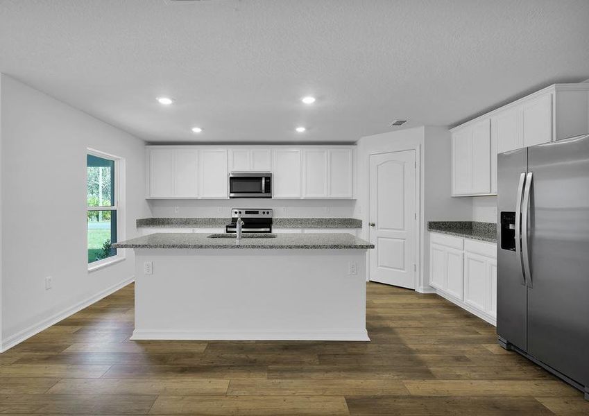 Overlooking the spacious family room, the sprawling granite countertops are sure to impress!