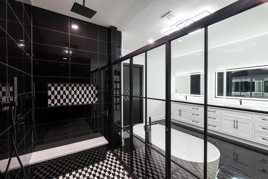 Bathroom featuring vanity and separate shower and tub