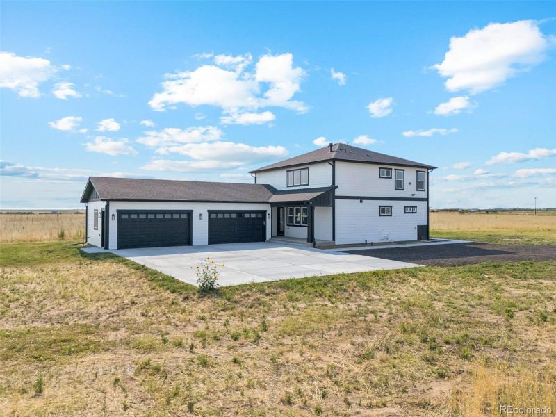 Front exterior of a new home in , Bennett, CO, highlighting curb appeal (Image 2).