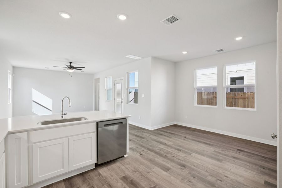 A kitchen with white cabinets.