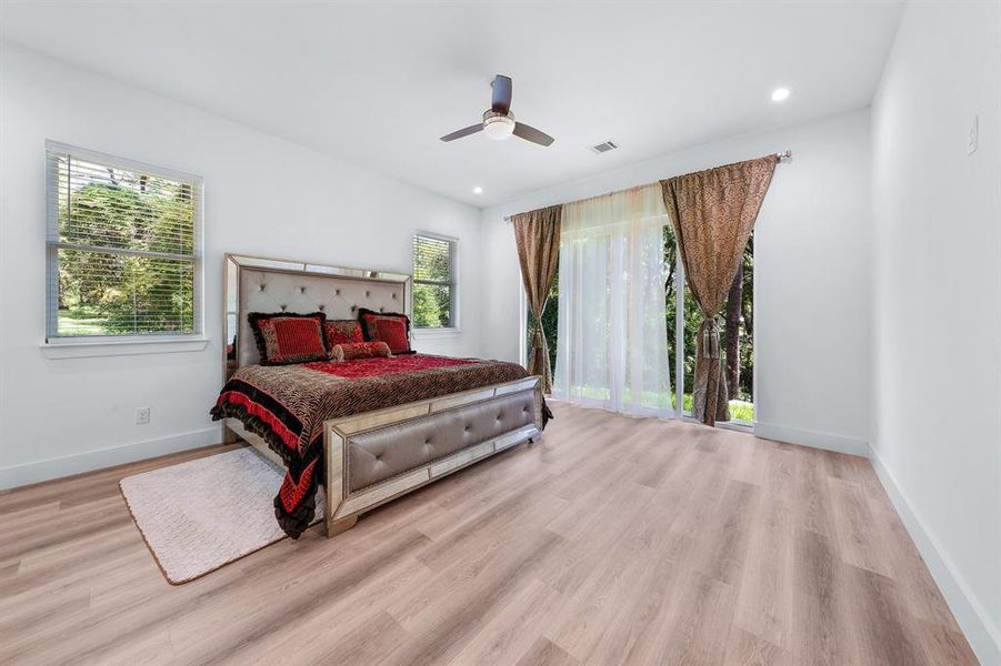 Bedroom with ceiling fan, light wood-style flooring, and recessed lighting Bedroom with ceiling fan, light wood-style flooring, and recessed lighting