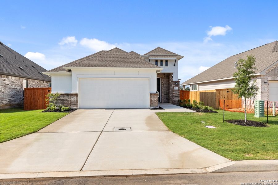 Front exterior of a new home in Megan's Landing, Castroville, TX, highlighting curb appeal (Image 22).