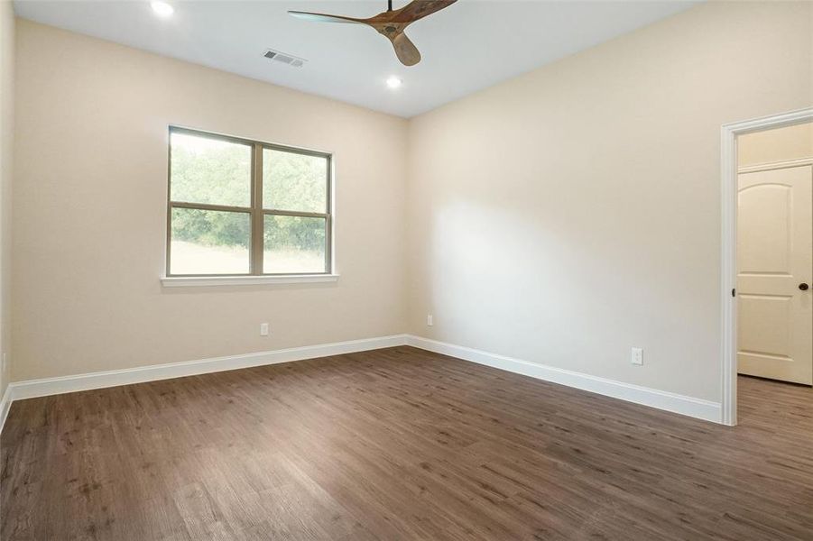 Unfurnished room with ceiling fan and dark hardwood / wood-style floors