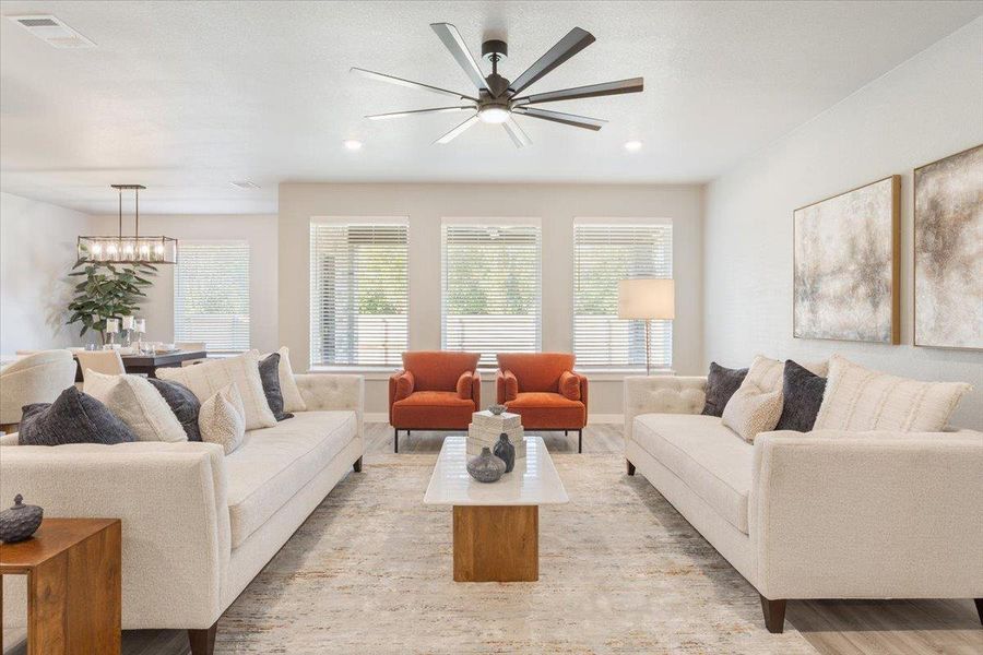Living room with a ceiling fan, recessed lighting, and wood finished floors Living room with a ceiling fan, recessed lighting, and wood finished floors