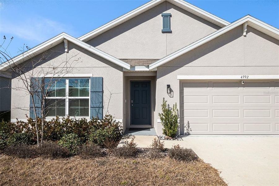 Front exterior of a new home in Fairways at Twisted Oaks, Beverly Hills, FL, highlighting curb appeal (Image 22).