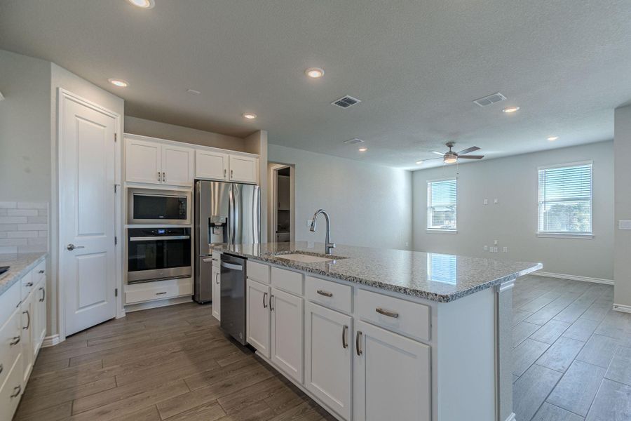 Kitchen featuring white cabinetry, stainless steel appliances, recessed lighting, and light wood-style flooring Kitchen featuring white cabinetry, stainless steel appliances, recessed lighting, and light wood-style flooring