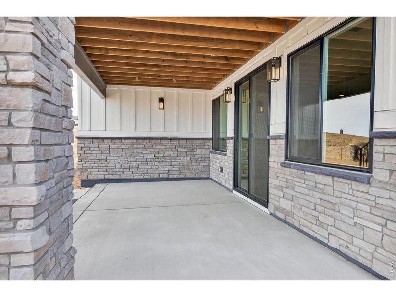 Exterior details and patio area of a home in RainDance, Windsor (Image 24).