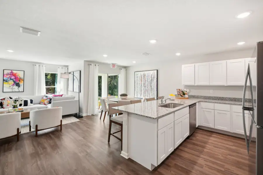 A kitchen with white cabinets.